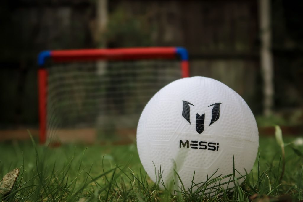 A close up of the Messi ball with the foldable goal in the background